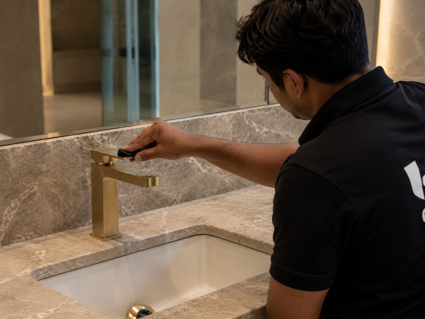 Urban Shieldz specialist applying nano protection to a premium bathroom fixture.